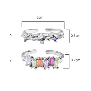 Detail view of silver rings with rainbow zircons showing precise height measurements