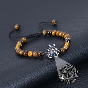 Detailed macro view of tiger eye beads bracelet with 100 languages projection stone