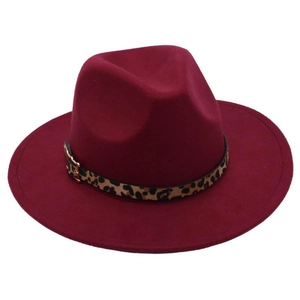 Detail view of burgundy wide brim fedora hat with leopard print band and metal buckle