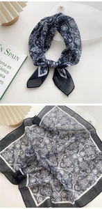 Close-up of black and white paisley cotton linen scarf with elegant translucent texture