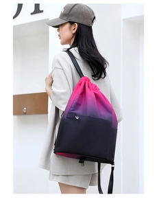 Rear view of a model wearing a waterproof drawstring gym sack with pink-to-black gradient