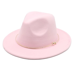 Detailed close-up of pink felt fedora hat with gold metal ring and bead decoration