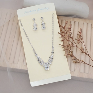 Macro shot of silver bridal jewelry set with sparkling teardrop crystals on a display card
