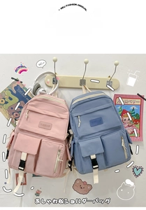 Detail of pink and blue canvas backpacks featuring multiple pockets and durable zippers