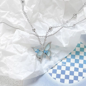 Double-layered silver necklace featuring a sea salt blue butterfly pendant and silver beads