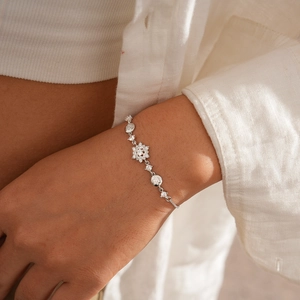 Detailed close-up of a silver snowflake flower zircon bracelet with adjustable chain
