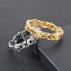 Macro detail of 316L stainless steel stamp on gold and silver skull Cuban bracelets