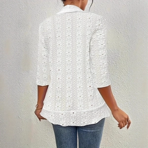 Detailed back view of white hollow lace embroidery and delicate eyelet texture on jacket
