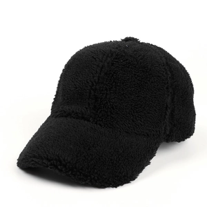 Detail showing plush sherpa fleece texture on black minimalist baseball cap