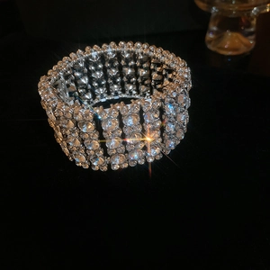 Close-up of wide multi-layer silver bracelet with shimmering rhinestones and luxury finish