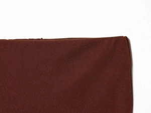 Close-up of deep brown knitted fabric texture showing elastic weave on long sleeve set