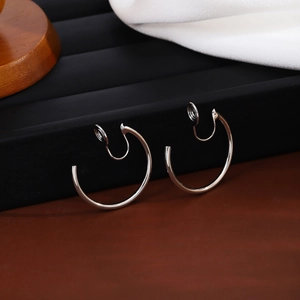 Detailed view of silver minimalist non-pierced clip-on hoop earrings on display