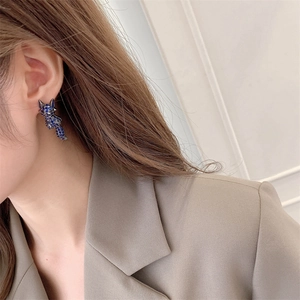 Close-up model shot of S925 fox stud earrings with elegant blue crystal stones