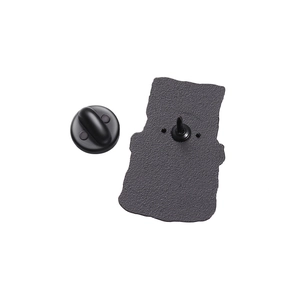 Detail of matte black typewriter pin back with sandblast texture and rubber clutch