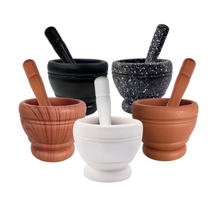 Five assorted styles of mortar and pestle sets in stone, ceramic and wood finishes