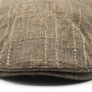 Close-up of brown plaid linen fabric and durable double-stitched seams on flat cap
