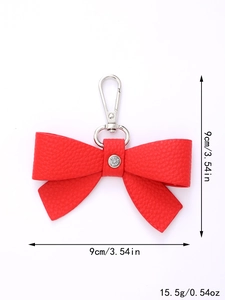 Detail of red leather bow keychain with crystal and measurements 9cm x 9cm