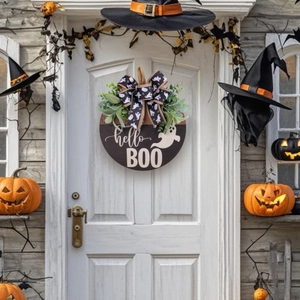 Halloween wooden hello BOO door sign with ghost pattern bow and green leaves