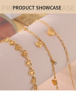 Close-up of three gold-plated heart anklets with intricate starburst textures and zircons