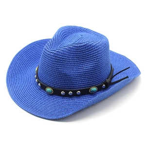 Detail of blue straw cowboy hat with faux leather band and turquoise studs