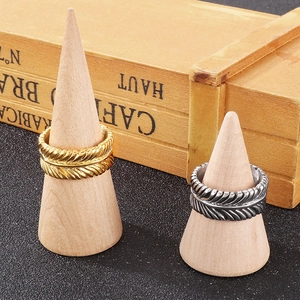 Detailed view of vintage feather texture and metallic luster on the punk steel rings
