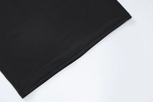 Detail of the high-quality double-needle stitching on the black knitted dress hemline