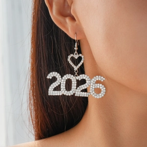 Close-up of sparkling 2026 rhinestone earrings worn on a model for New Year style