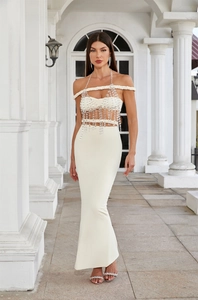 Detailed view of white off-shoulder top with crystal fringe and long fishtail skirt