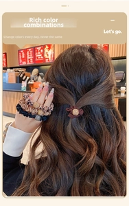 Detail of high-elastic scrunchies with metallic beads on model in warm cafe light