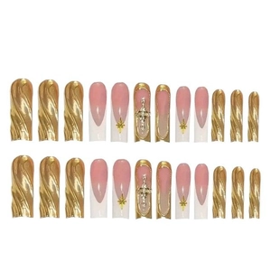 Long coffin press-on nails with gold mirror wave patterns and metallic cross accents