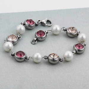 Elegant silver bracelet featuring white pearls with pink and champagne synthetic crystals