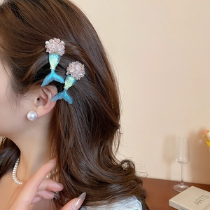 Detailed view of mermaid tail hair clips with blue gradient resin and pearl accents