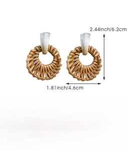 Detail view of handmade woven raffia round earrings with resin studs and size dimensions