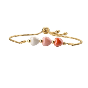 Adjustable gold chain bracelet with three ceramic heart beads in white and pink tones