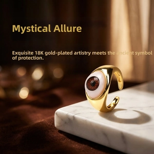 Detail of 18K gold-plated Evil Eye resin ring displayed on premium white marble