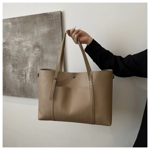 Close-up of khaki PU leather tote bag with adjustable shoulder strap and external pocket