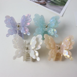 Set of four iridescent butterfly hair claws in purple, blue, white, and pink acetate