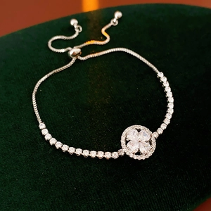 Detailed slider clasp of the silver clover bracelet with adjustable tennis chain and gems