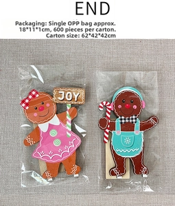 Detail view of wooden gingerbread man and girl Christmas tabletop decorations in packaging