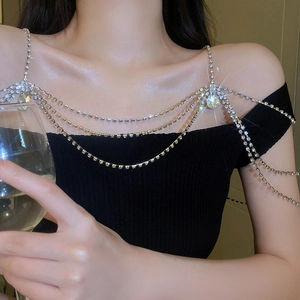 Close-up of sparkling rhinestone multi-layer shoulder body chain on a model