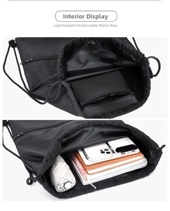 Detail view of black nylon drawstring bag showing interior capacity and zipper pocket