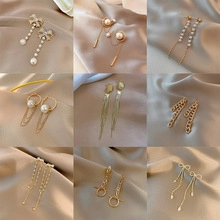 Collage of nine elegant gold earrings featuring pearls, tassels, and geometric shapes