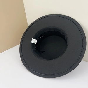 Detail view of the inner label showing 35% cotton and 65% polyester composition on a black hat
