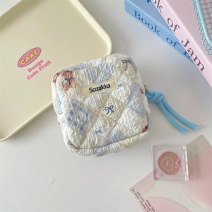Detailed shot of quilted fabric pattern with cute bear motif and blue zipper pull