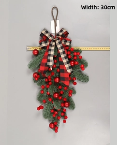 Detailed view of Christmas teardrop swag with red berries and plaid bow measuring 30cm wide