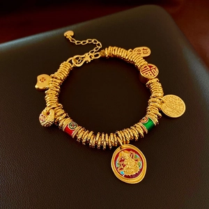 Macro detail of gold-plated bracelet with Fortune pendants and colorful enamel charms