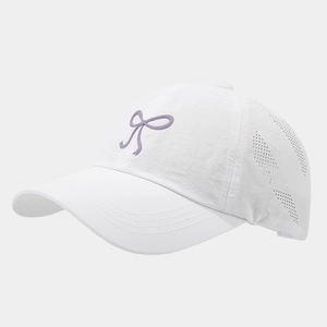 Detail of white baseball cap showing breathable laser-cut holes and purple bow embroidery