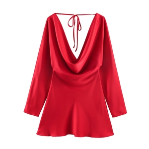 Detail of red satin dress featuring a draped cowl neck and silky smooth texture