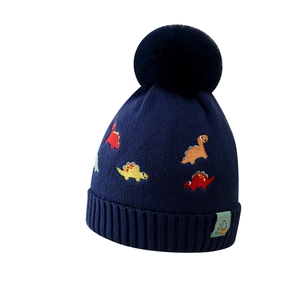 Bonnet en tricot bleu marine pour garçon avec broderies dinosaures et pompon doux