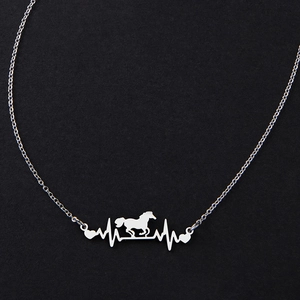 Close-up of silver heartbeat necklace featuring a galloping horse silhouette and heart charms